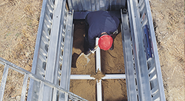 Man installing National Trench Safety shielding